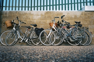 Four bikes leaning against wall